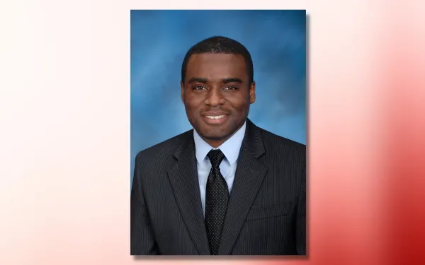 hervey abotsi headshot on red and white ombre background