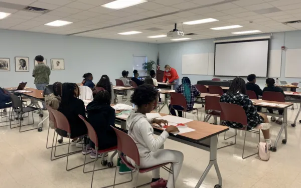 Image from Hidden Figures Workshop on dragon fractals. Features rows of students working at desks.